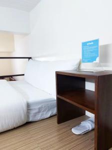 a bedroom with a bed and a laptop on a table at airobedz MANILA - A Value Hotel in Manila +43 photos