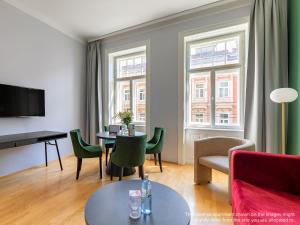 a living room with a table and chairs at Numa Vienna Strauss in Vienna +48 photos