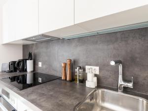 a kitchen with a stainless steel counter top with a sink at limehome Linz Hopfengasse in Linz