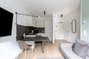 a living room with a table and a couch at Limehome Linz Hopfengasse in Linz