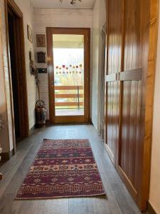 a hallway with a door and a rug on the floor at Casa con vista in Corniolo
