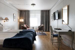 Elite Stora Hotellet tesisinde bir odada yatak veya yataklar
