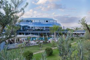 a large blue building with a restaurant in front of it at Liu Resorts in Side