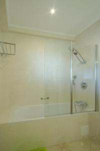 ラゴスにあるCasa Monte Cristo Apartments - Limeのバスルーム(ガラスドア付きのシャワー付)