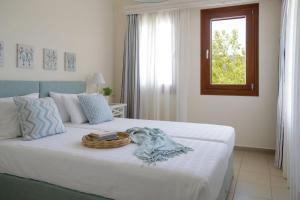 a bedroom with a bed with a basket on it at Skopelos Summer Homes in Skopelos Town
