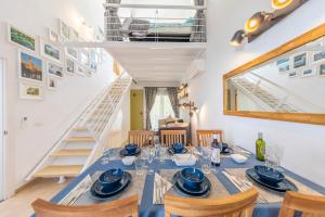 a dining room with a table and chairs and a staircase at MEDANO4YOU Barefoot Beach House in El Médano