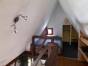 a bedroom with a bed and a lamp in a attic at Holiday village in Réclinghem