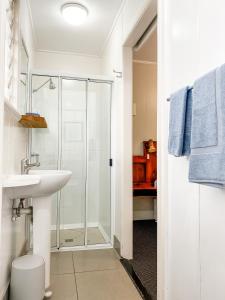 a bathroom with a shower, sink, and toilet at Pacific Sun Bargara in Bargara