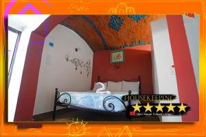 a bedroom with a bed with a painting on it at Opal privat nubian hotel in Aswan