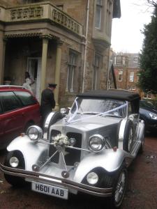 an old car parked in front of a building at Newhall in Glasgow