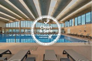 a large pool with a sign that reads clean safe at Hotel Golf Mar in Maceira