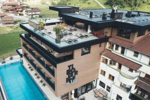 an aerial view of a building with a swimming pool at Hotel Tirolerhof 4 Sterne Superior in Tux