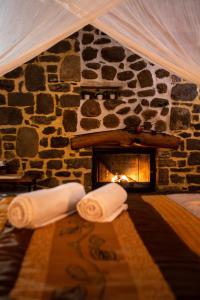 a fireplace in a stone wall with rolls of paper at La Moara Boutique Hotel in Kraniá