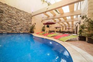 a large swimming pool in a building with an indoor at Gerasa Hotel in Amman