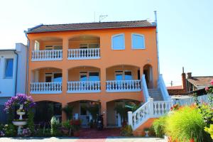 a large orange house with white balconies at Studio Florida in Štúrovo