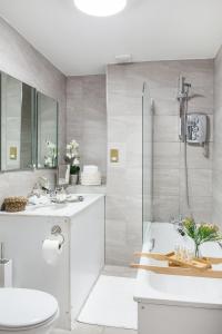 a bathroom with a shower and a toilet and a sink at Park Lane Apartments - Clarges Street in London +160 photos