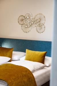 a bedroom with two beds with yellow pillows at Apart of me Klagenfurt in Klagenfurt