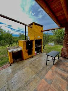 a yellow building with a sink on a patio at Luna de los Molles in Villa Las Rosas