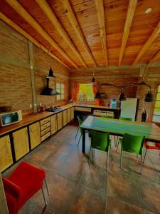 a kitchen with a table and chairs in a room at Luna de los Molles in Villa Las Rosas