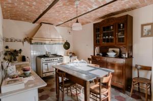 a kitchen with a table and chairs and a stove at La Corte di Lu in Rocca D'Arazzo