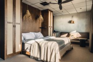 a bedroom with a bed and a ceiling fan at Ocean Hotel in Falkenberg