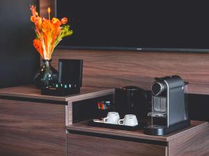 a room with a coffee machine on a table at Novotel Paris Vaugirard Montparnasse in Paris
