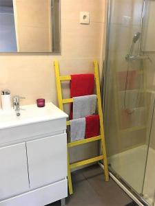 a bathroom with a towel rack next to a shower at King Garfield House - Espaço de charme em Bragança in Bragança