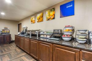 a food counter in a hotel with bowls of food at Comfort Inn in Story City