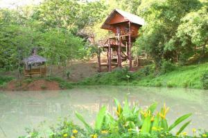 uma casa na árvore ao lado de um corpo de água em Treehouse Holidays-Lake View em Ko Yao Noi