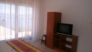 a living room with a television and a window at Villa Novak in Ohrid