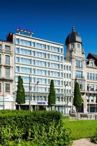 a large building with a clock on the front of it at Park Inn by Radisson Antwerpen in Antwerp
