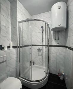 a shower with a glass door in a bathroom at Stan na dan Bella in Banja Luka +11 photos