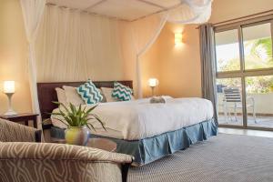 a bedroom with a large bed and a couch at Lake Kariba Inns in Siavonga +18 photos