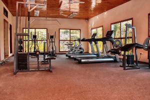 a gym with several treadmills and exercise bikes at Lake Kariba Inns in Siavonga