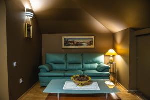 a living room with a blue couch and a table at Vila Sonja in Predeal