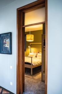 a bedroom with a bed and a glass doorway at Vila Sonja in Predeal