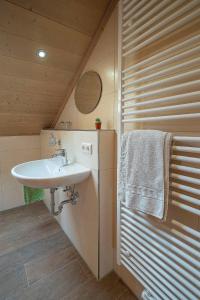 a bathroom with a sink and a towel on a wall at Ferienwohnung Martin in Seeg