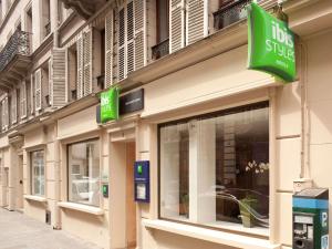 a store front with a sign for aoks shop at ibis Styles Paris Opera Lafayette in Paris