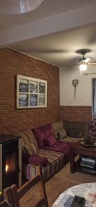 salon z kanapą i ceglaną ścianą w obiekcie My Love w mieście Arenas de San Pedro