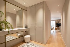 a bathroom with a mirror and a walk in closet at housingcoruña REAL58 in A Coruña +42 photos