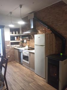 a kitchen with a white refrigerator and a stove at My Love in Arenas de San Pedro