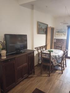a living room with a table and a flat screen tv at My Love in Arenas de San Pedro