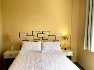 Studio Albatroz 2 Master Collection في باسو فوندو: غرفة نوم بسرير ولحاف ابيض