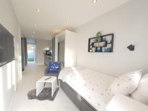 a small bedroom with a bed and a couch at Modern Studio apartment in Newcastle upon Tyne in Newcastle upon Tyne