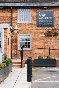 a brick building with a sign on the side of it at The Knife & Cleaver in Houghton Conquest