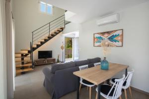 a living room with a couch and a table at Grappolo Lefkada Villas - Vilana ideal for families and small groups in Apolpaina