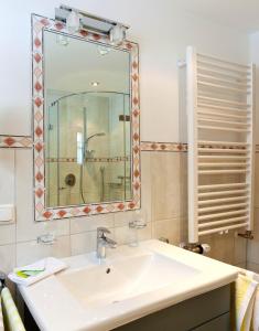 a bathroom with a sink and a mirror at Ferienwohnungen Zweckl in Marktschellenberg