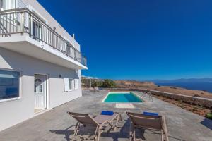 a villa with a swimming pool and a balcony at Tranquil sea view villa with private pool, just 2km from the beach! in Agia Galini