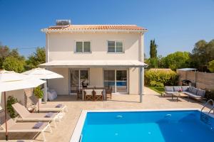a villa with a swimming pool and a house at Grappolo Lefkada Villas - Vilana ideal for families and small groups in Apolpaina