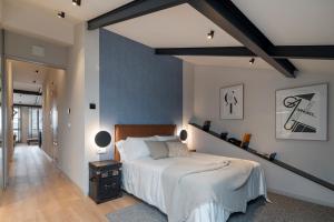 a bedroom with a large bed and a blue wall at housingcoruña REAL58 in A Coruña